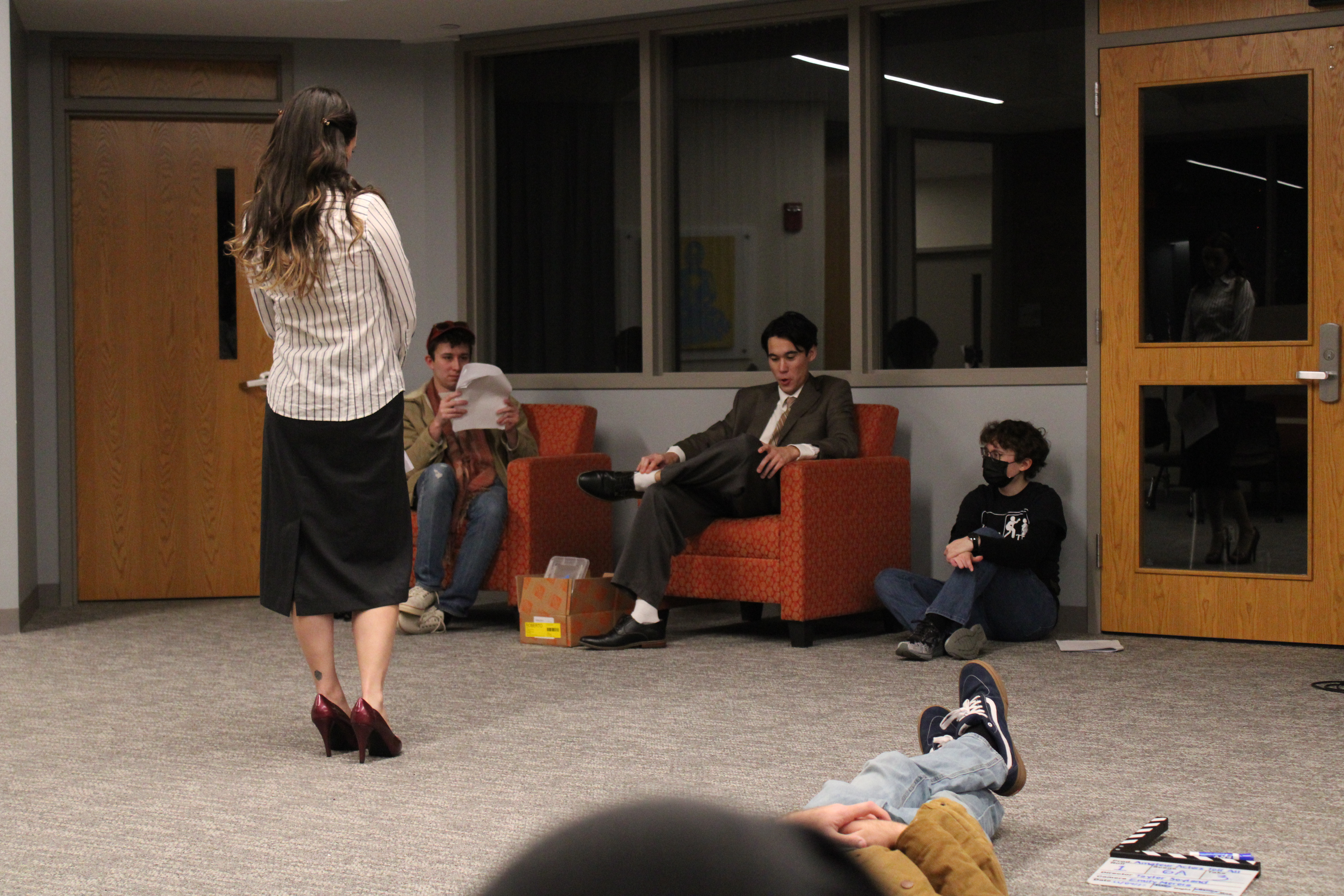 The actress and two actors, in costume, talk with Taylor.
